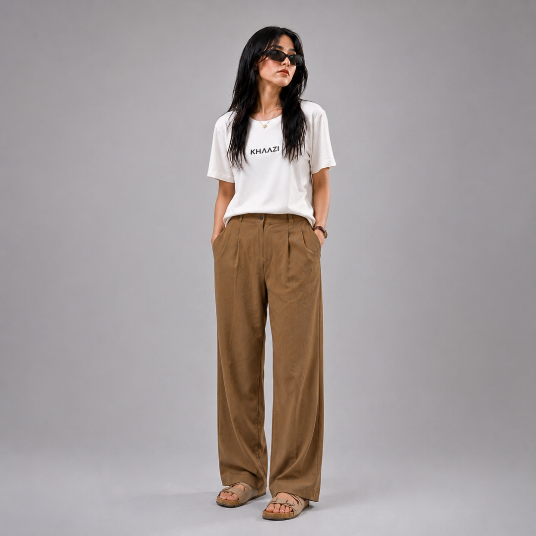 Khaazi women's white crew neck t-shirt with logo print, featuring a relaxed fit and minimalist casual design, styled in a modern studio setting.