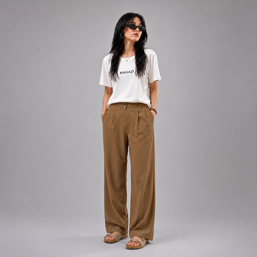 Khaazi women's white crew neck t-shirt with logo print, featuring a relaxed fit and minimalist casual design, styled in a modern studio setting.