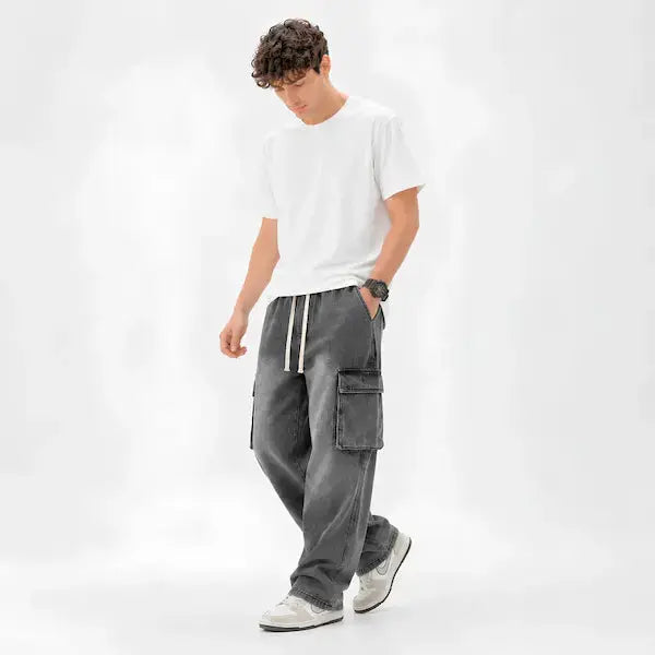 "Man wearing grey denim cargo pants with white t-shirt and sneakers"