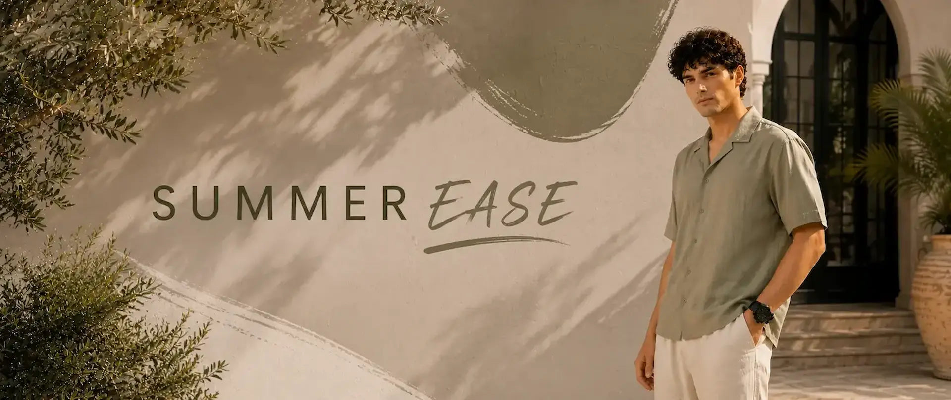 Man standing in front of a building with 'Summer Ease' text and greenery.
