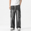 Washed black wide leg cargo jeans featuring multiple utility pockets, a relaxed baggy fit, and a vintage streetwear-inspired denim design for casual everyday wear.