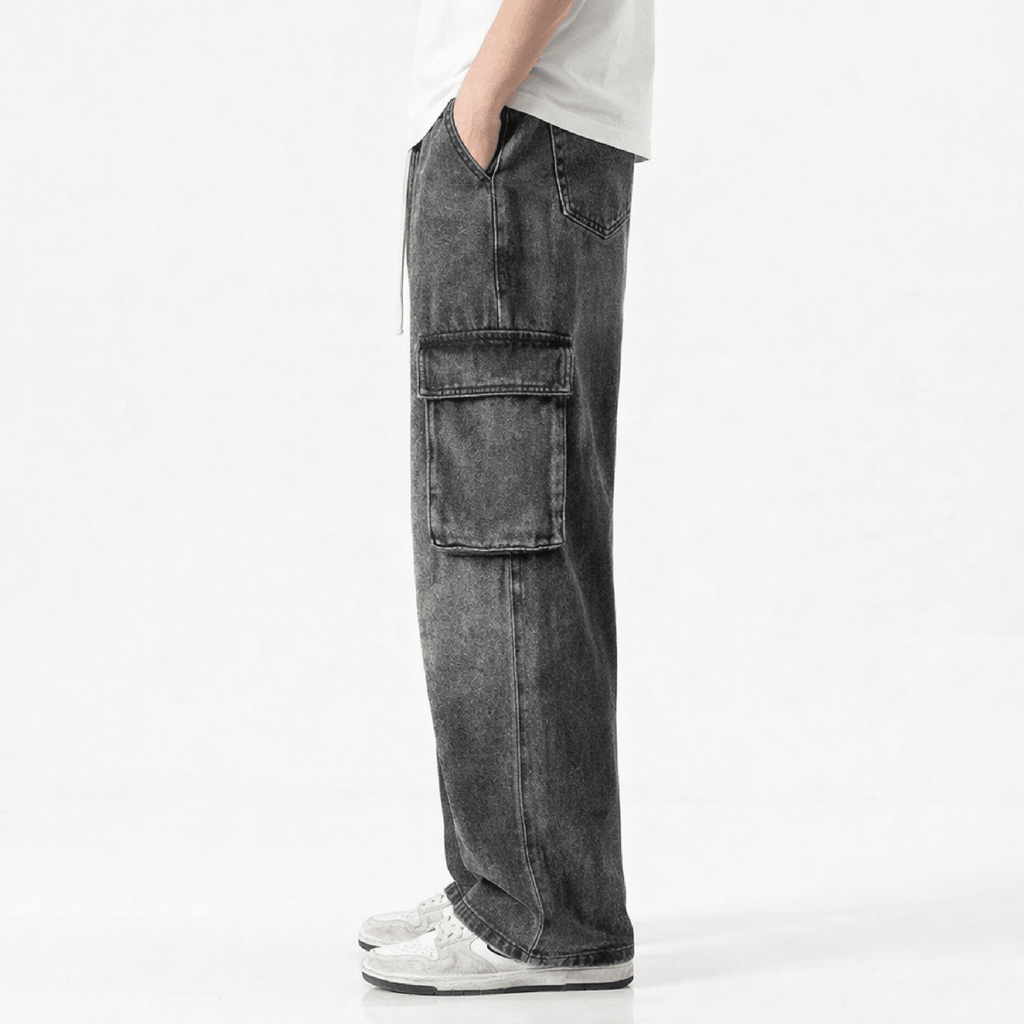 Washed black wide leg cargo jeans featuring multiple utility pockets, a relaxed baggy fit, and a vintage streetwear-inspired denim design for casual everyday wear.