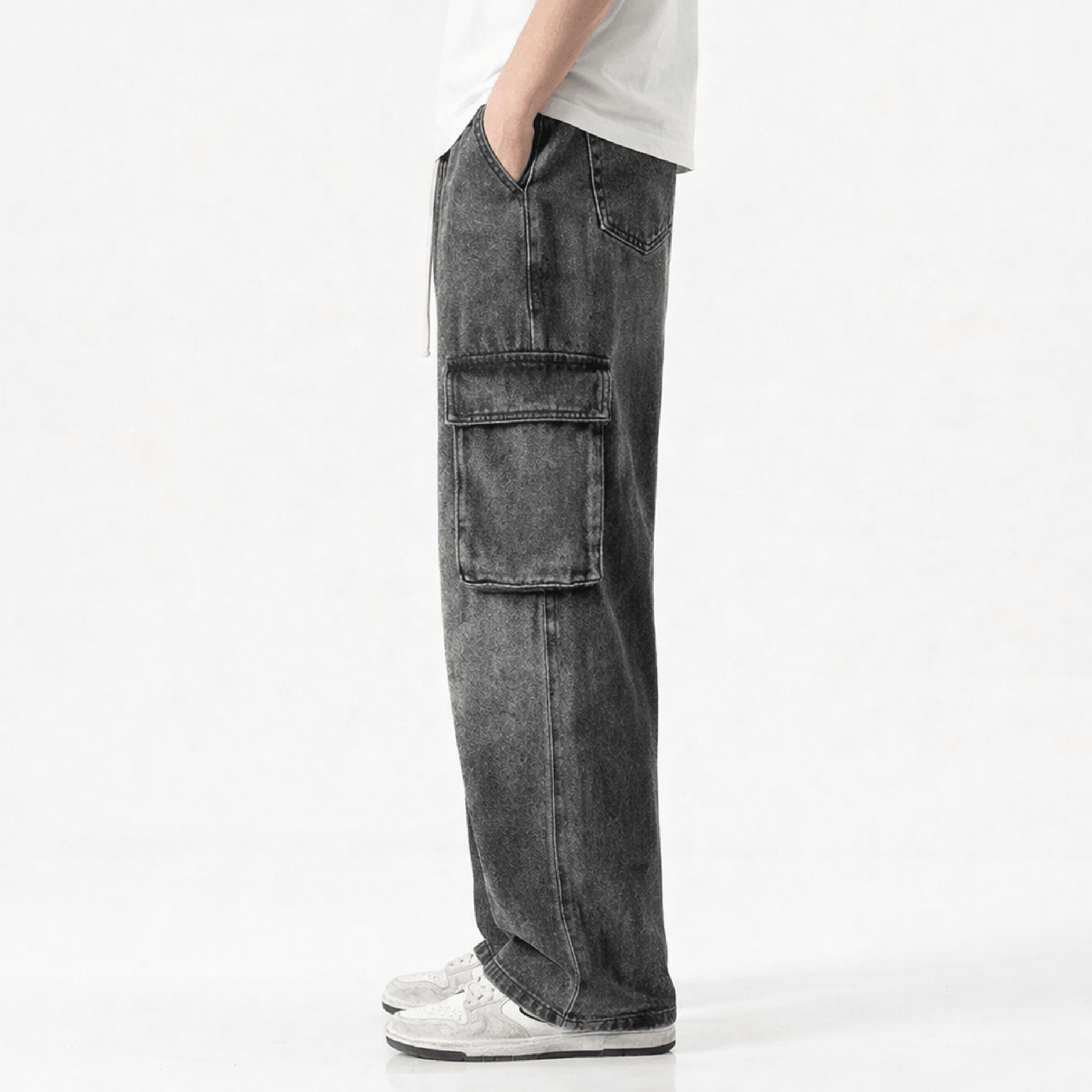Washed black wide leg cargo jeans featuring multiple utility pockets, a relaxed baggy fit, and a vintage streetwear-inspired denim design for casual everyday wear.